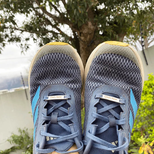 Image of etched shoe tags on a pair of children's trainers. Showing what they would look like. 