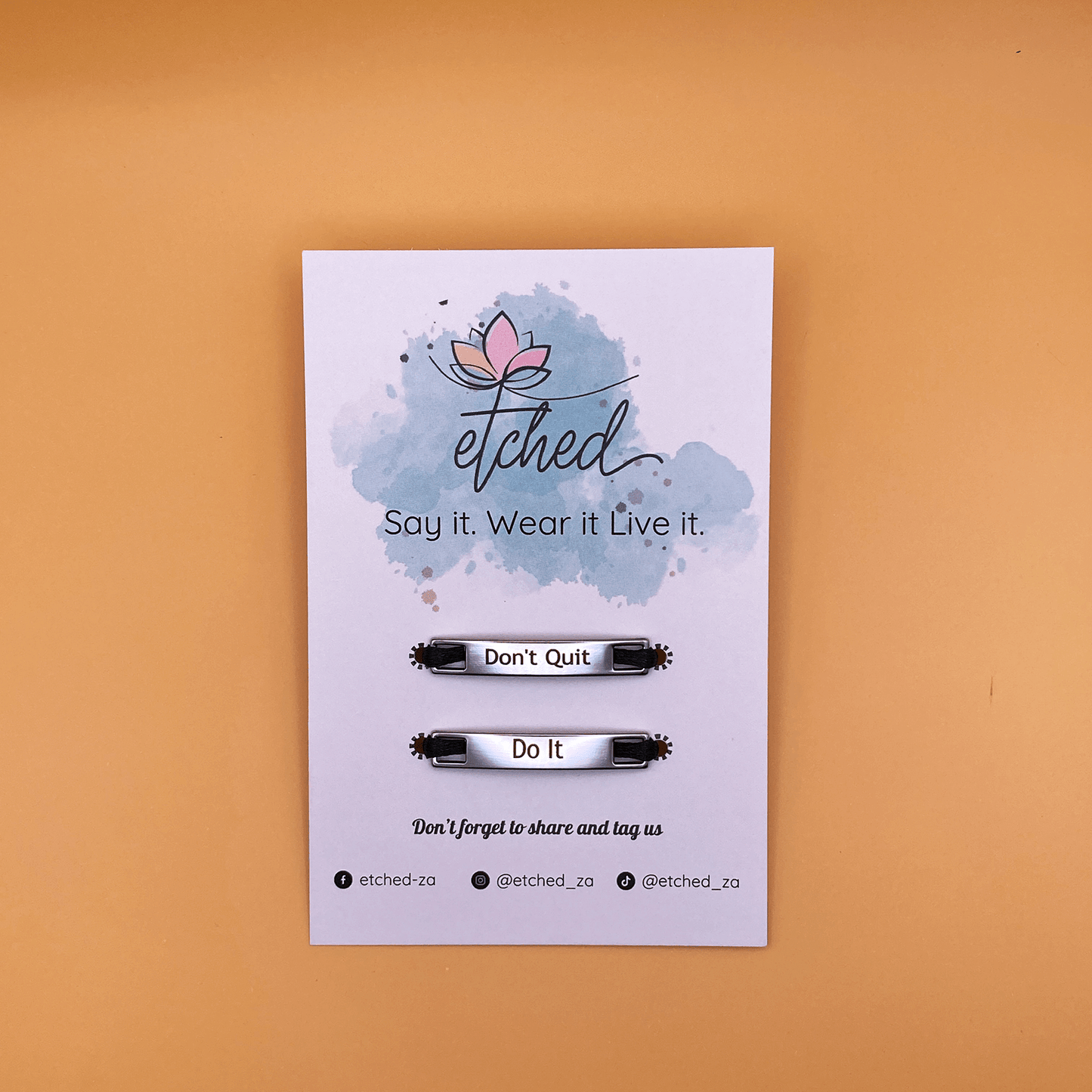 Image of etched product card showing the Don't Quit Do It shoe tags on a mustard background
