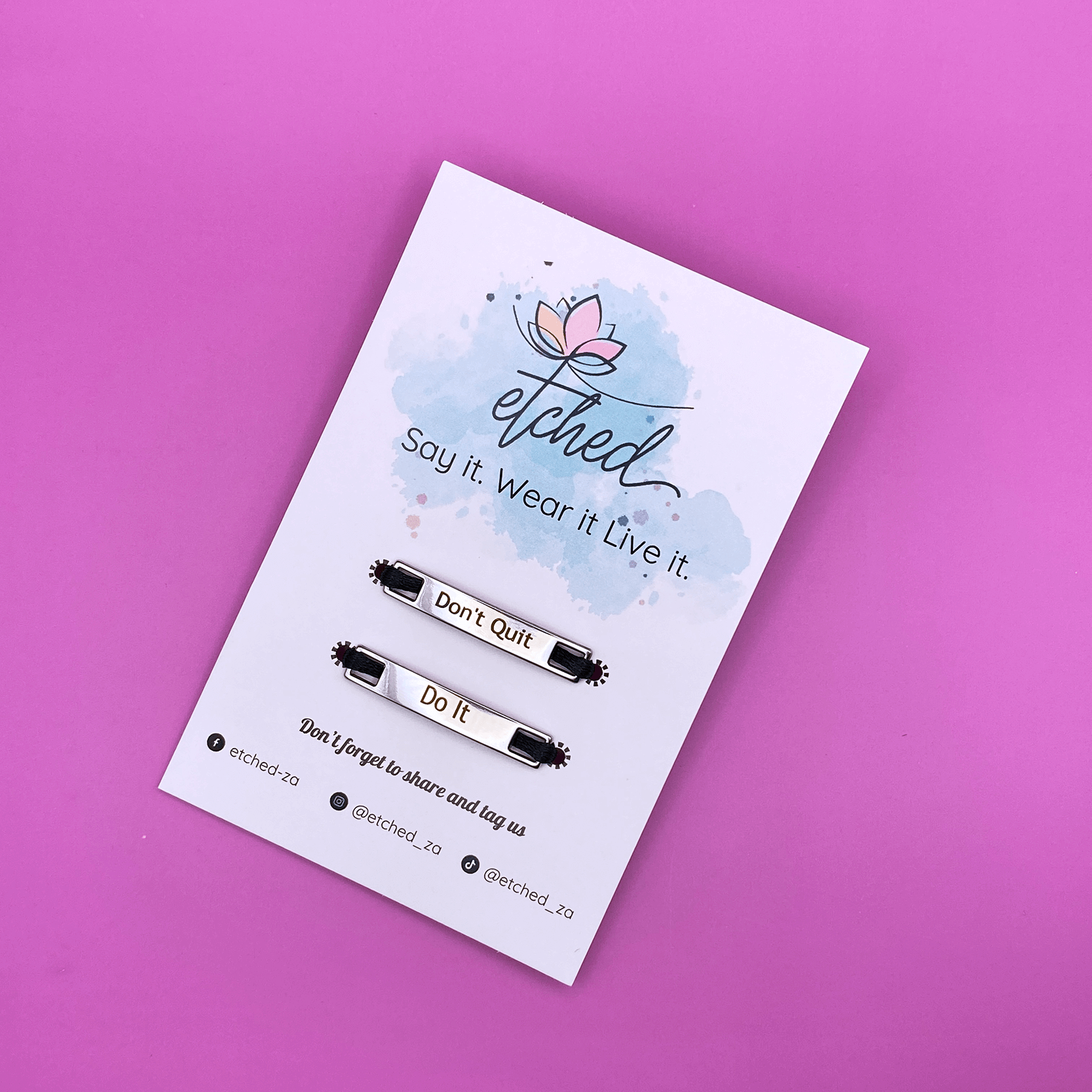 Image of etched product card showing the Don't Quit Do It shoe tags on a pink background
