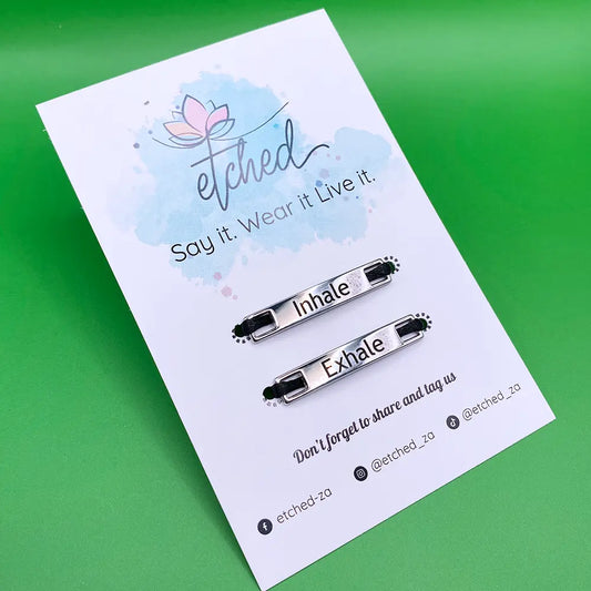 Shoe tags saying inhale exhale on a green background