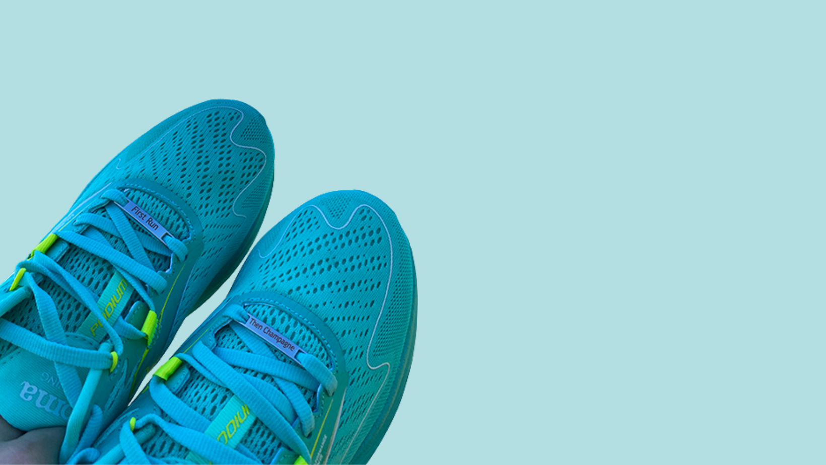 Image of etched shoe tags saying First Run Then Champagne on a pair of shoes on a blue background