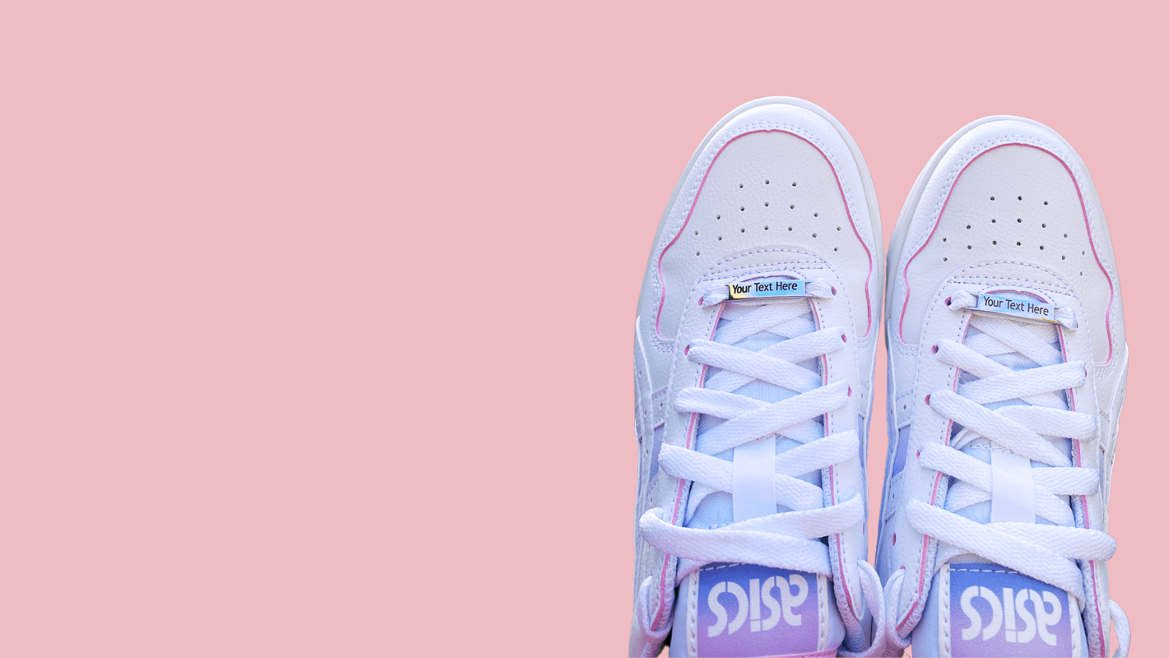 Image of etched shoe tags saying Your Text Here on a pair of shoes on a pink background
